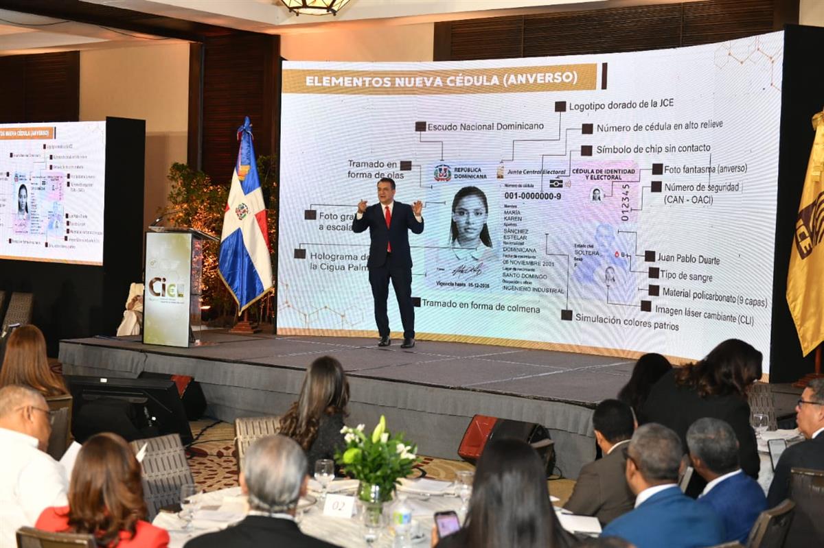 The JCE presenting the new Dominican cédula design, showing an official specimen card with sample data and labeled security features